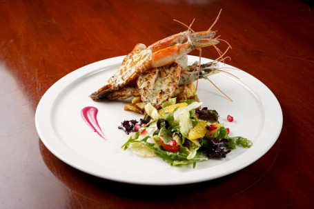 Grilled King Prawns, Mustard Cream Sauce, Crushed Potatoes, Citrus Leafy Salad.