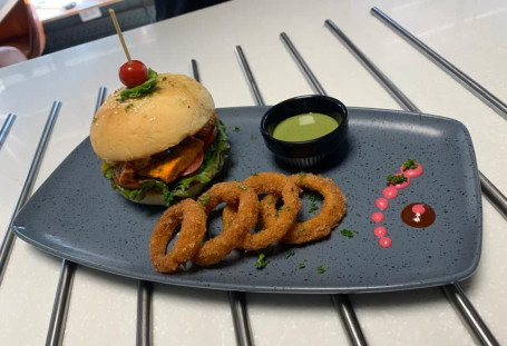 Paneer Tikka Masala Burger With Onion Rings And Mint Youghurt