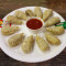 Steam Chicken Momos Served With Red Spicy Chutney Mevnies