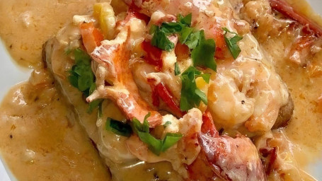 Lobster, Shrimp Creamy White Wine Sauce Over Grit Cake