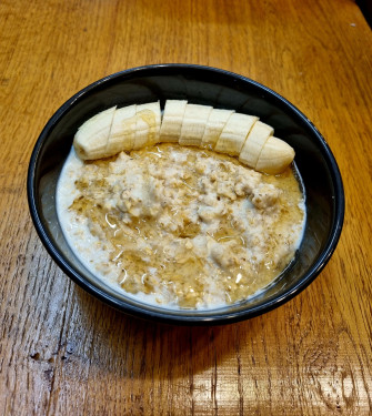 Porridge Served With Raw Cacao And Chocolate Nibs