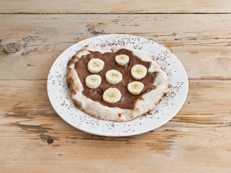 Sweet Pizza With Nutella, Pineapple, Hazelnuts And Icing Sugar